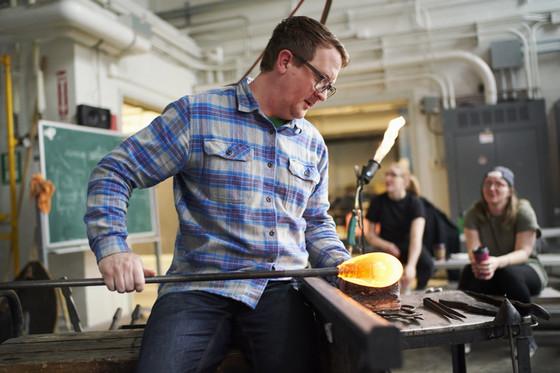 Professor demonstrating glass blowing